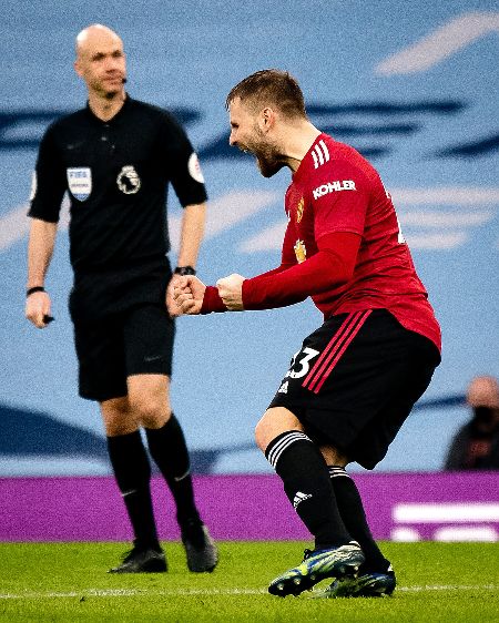 Luke Shaw celebrating a goal after scoring against rivals Manchester City.